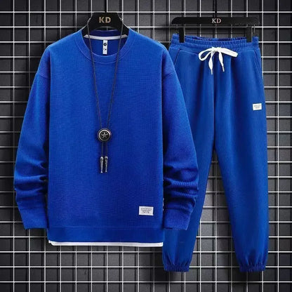 Blue sweater and pants set with a necklace on a checkered background