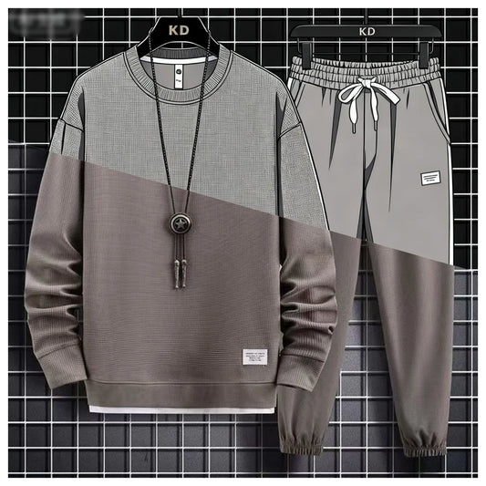 Gray and brown sweatshirt and pants set on hangers against a grid background